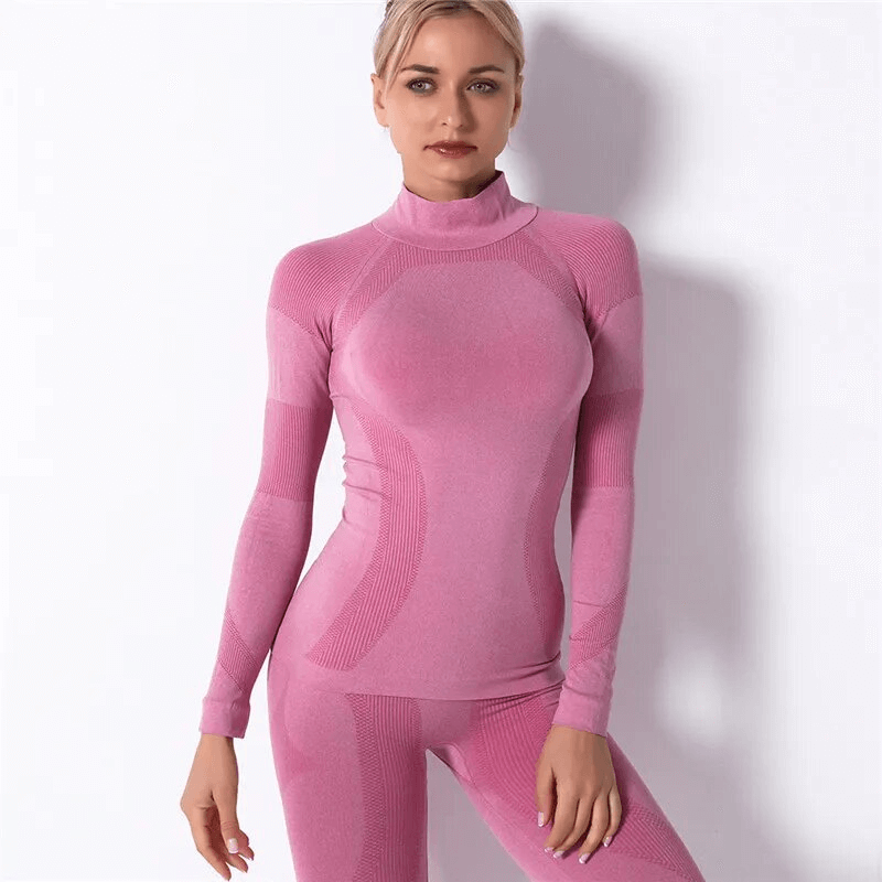 Woman wearing pink stretchy seamless long sleeves top for sport, showcasing comfort and softness, ideal for yoga and athletics.
